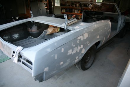 Final detail work with glazing compound on 67 GTO quarter panels