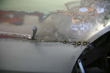 Passenger side quarter panel patch being butt welded to original quarter metal