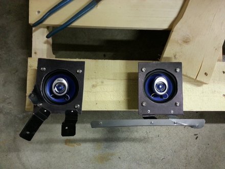 Plates and brackets fabricated to fit speakers under dash of Pontiac GTO